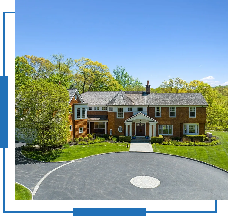 A large brick house with a circular driveway.